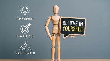 Wooden mannequin holding Believe in Yourself sign for digital marketing services vision