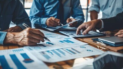 SearchNRank SEO specialists analyzing digital marketing analytics reports and data charts around a table